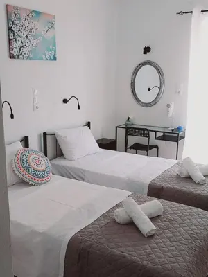 two beds sitting next to each other in a room at Hotel Liliana in Agia Marina Aegina