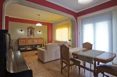 a living room with a table and a couch at Baroness Apt Piraeus Ctr 3BR, 2BA, AC, Walk to sea in Piraeus