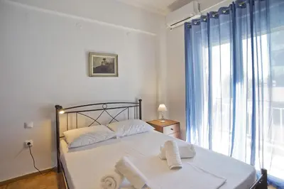 a bedroom with a bed with two towels on it at Baroness Apt Piraeus Ctr 3BR, 2BA, AC, Walk to sea in Piraeus