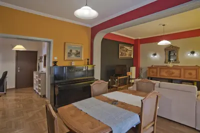 a living room with a table and a couch at Baroness Apt Piraeus Ctr 3BR, 2BA, AC, Walk to sea in Piraeus