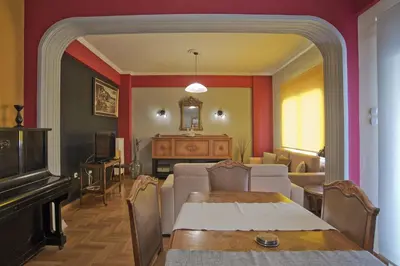 a living room with a couch and a table at Baroness Apt Piraeus Ctr 3BR, 2BA, AC, Walk to sea in Piraeus