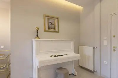 a white fireplace with flowers on it in a room at Chrisostomou Square 14 Gold Apartment in Athens