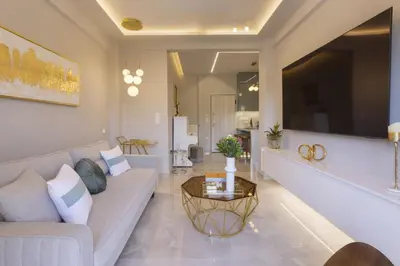a living room with a couch and a table at Chrisostomou Square 14 Gold Apartment in Athens