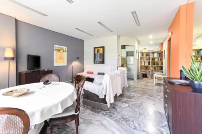 a bedroom with a bed and a living room at The Holiday Place in Voula for 4 by Filos Inc in Athens