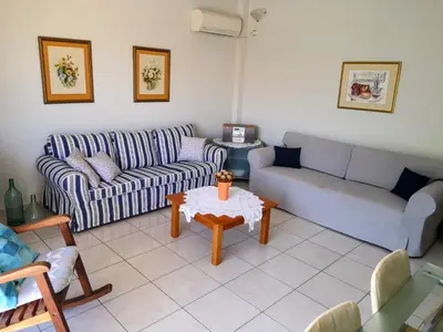 a living room with a couch and a table at Country House in Anavyssos in Anavissos