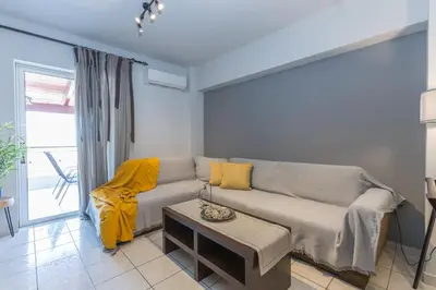 a living room with a couch and a table at Raise Piraeus Harbor Flats in Piraeus