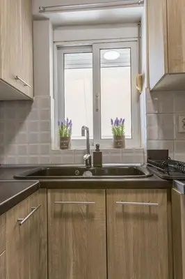 a kitchen with a sink and a window at Raise Piraeus Harbor Flats in Piraeus