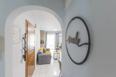 a hallway with a mirror and a living room at Raise Piraeus Harbor Flats in Piraeus