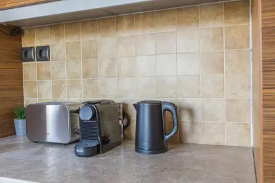 a kitchen counter with a toaster and a coffee maker at Raise Piraeus Harbor Flats in Piraeus