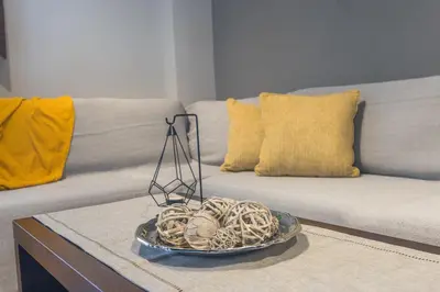 a plate of food on a table next to a couch at Raise Piraeus Harbor Flats in Piraeus