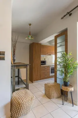 a kitchen with a table and two stools and a table at Raise Piraeus Harbor Flats in Piraeus