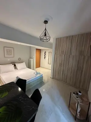 a bedroom with a bed and a table in it at Just For Two in Athens