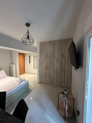 a bedroom with a bed and a flat screen tv at Just For Two in Athens