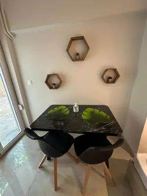 a dining room table with two chairs and a black table at Just For Two in Athens