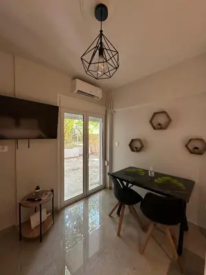 a dining room with a table and chairs and a window at Just For Two in Athens