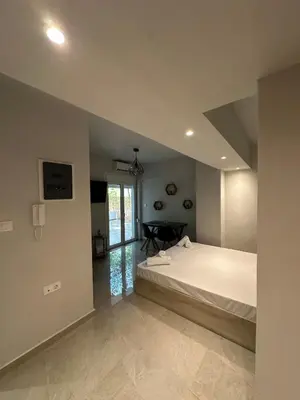a bedroom with a bed and a table in it at Just For Two in Athens
