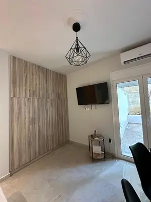 a living room with a flat screen tv on the wall at Just For Two in Athens