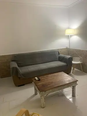 a living room with a couch and a coffee table at Dori's Seaside Apartment in Athens
