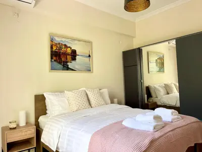 a bedroom with a bed with towels on it at Voula Casita in Athens