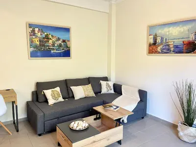 a living room with a couch and a table at Voula Casita in Athens