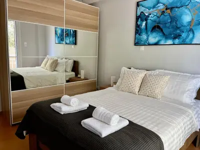 a bedroom with a bed with towels on it at Voula Casita in Athens