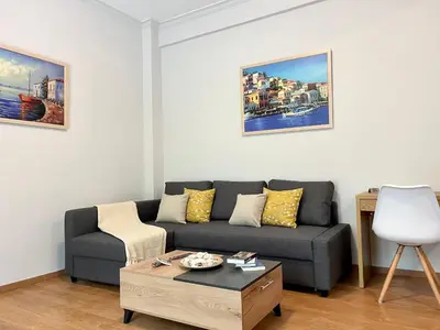 a living room with a couch and a coffee table at Voula Casita in Athens