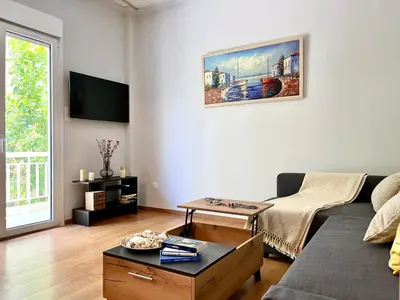 a living room with a couch and a table at Voula Casita in Athens