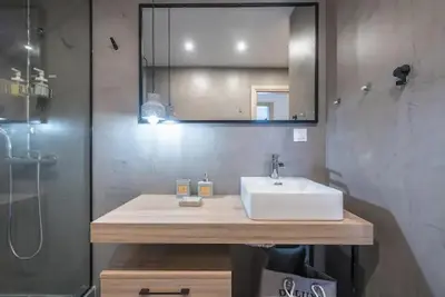 a bathroom with a sink and a mirror and a shower at Elegant Apartment in Athens