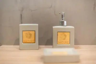 two bottles ofodorizers sitting on a wooden table at Elegant Apartment in Athens