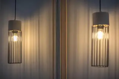 two lights hanging from a wall with curtains at Elegant Apartment in Athens