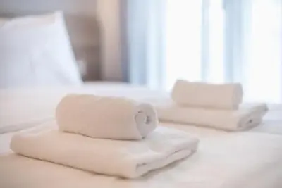 three towels sitting on top of a table at Elegant Apartment in Athens