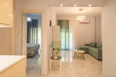a living room with a couch and a table at Simpli-city home in Piraeus