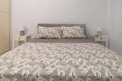 a bedroom with a large bed with two night stands at Simpli-city home in Piraeus