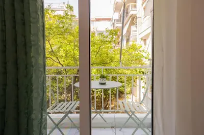 a view of a balcony with a table and chairs at Simpli-city home in Piraeus