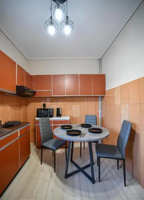 a kitchen with a table and chairs in a room at Spacious Apartment near Panormou Metro with Self Check-in in Athens