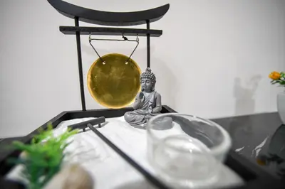 a small buddha statue sitting on a table with a scale at Spacious Apartment near Panormou Metro with Self Check-in in Athens
