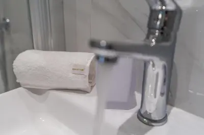 a roll of toilet paper sitting on top of a sink at Voula Riviera Luxury Apartment in Athens