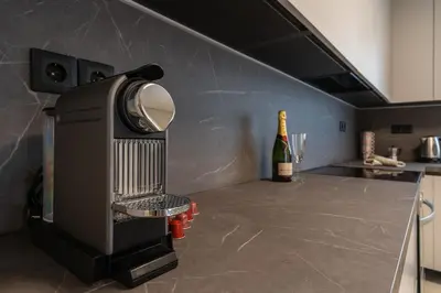 a kitchen with a bottle of wine on a counter at Voula Riviera Luxury Apartment in Athens