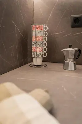 a vase sitting on a table next to a coffee pot at Voula Riviera Luxury Apartment in Athens
