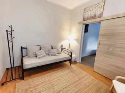 a living room with a couch and a bed at Harmony Apartment Near Metro Station in Athens