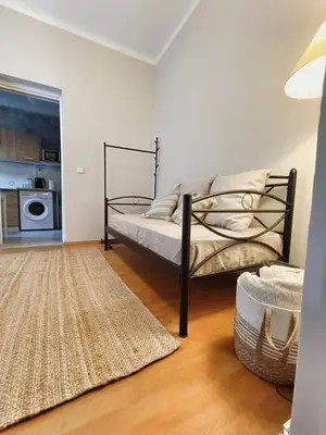 a bedroom with a bed and a rug at Harmony Apartment Near Metro Station in Athens