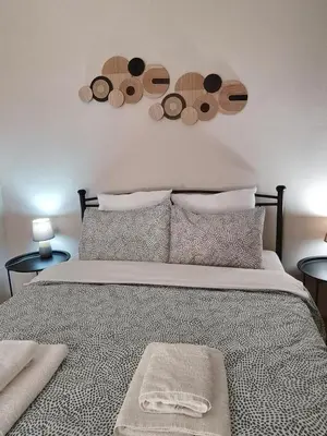 a bedroom with a bed with two plates on the wall at Harmony Apartment Near Metro Station in Athens