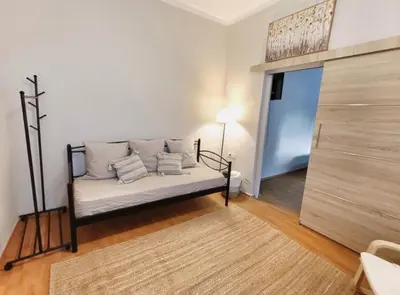 a living room with a couch and a bed in a room at Harmony Apartment Near Metro Station in Athens