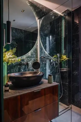 a bathroom with a vessel sink and a glass wall at Emerald Stone Apartment Varkiza in Vari