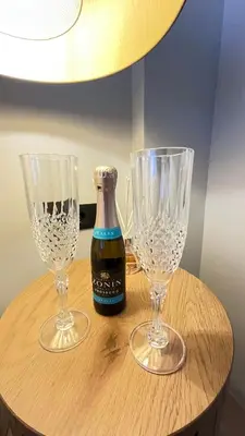 two empty wine glasses and a bottle on a table at Luxury Haven in Saronida