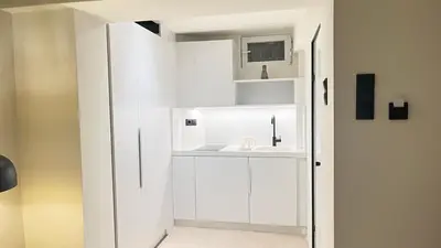 a small bathroom with a white cabinet and a sink at Luxury Haven in Saronida