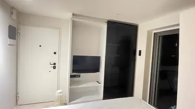 a bedroom with a mirror and a television in it at Luxury Haven in Saronida