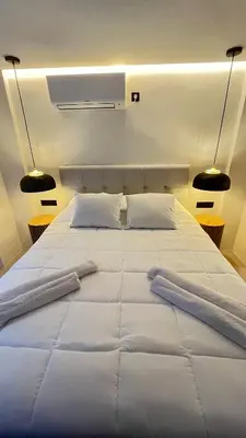 a large white bed in a room with two pillows at Luxury Haven in Saronida