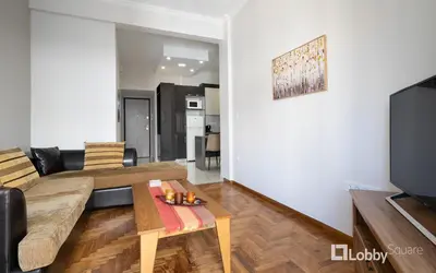 a living room with a couch and a table at Aria Apartment in Athens