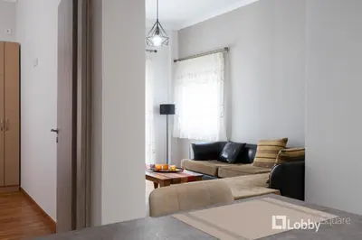 a living room with a couch and a table at Aria Apartment in Athens